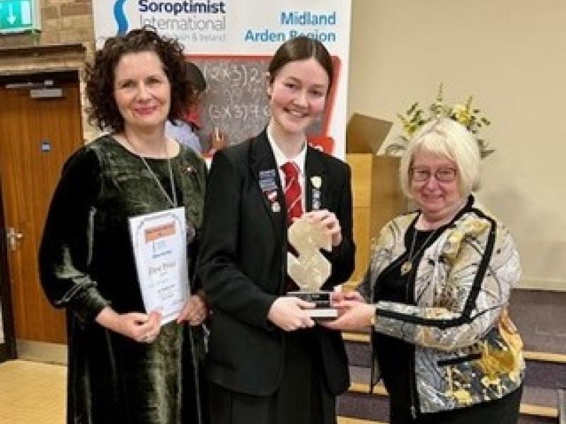 Aoife McNamara being presented with the trophy by Maureen McGuire President, Immediate Past President Soroptimist International, and the head judge, Catherine Williamson, Past President of the National Speakers Association.