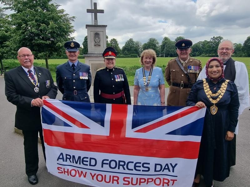 Ken Russell (Chair of RBL Shirley), Squadron Leader Dave Kerrison, Lesley Wilde TD DL, Elaine Butler (President of the Warwickshire & Birmingham County RBL), Captain Alan O'Brien, Mayor of Solihull and Mayor's Chaplain Revd Paul Day holding the Armed Forces Day flag at the RBL Memorial in Shirley Park