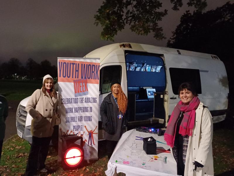 People waiting outside the youth bus to welcome young people