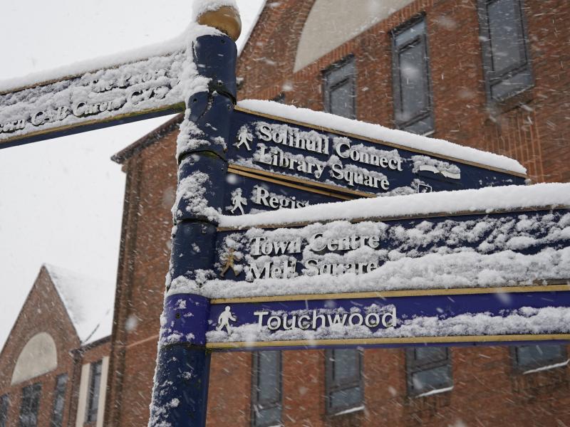 a snow covered sign in solihull town centre