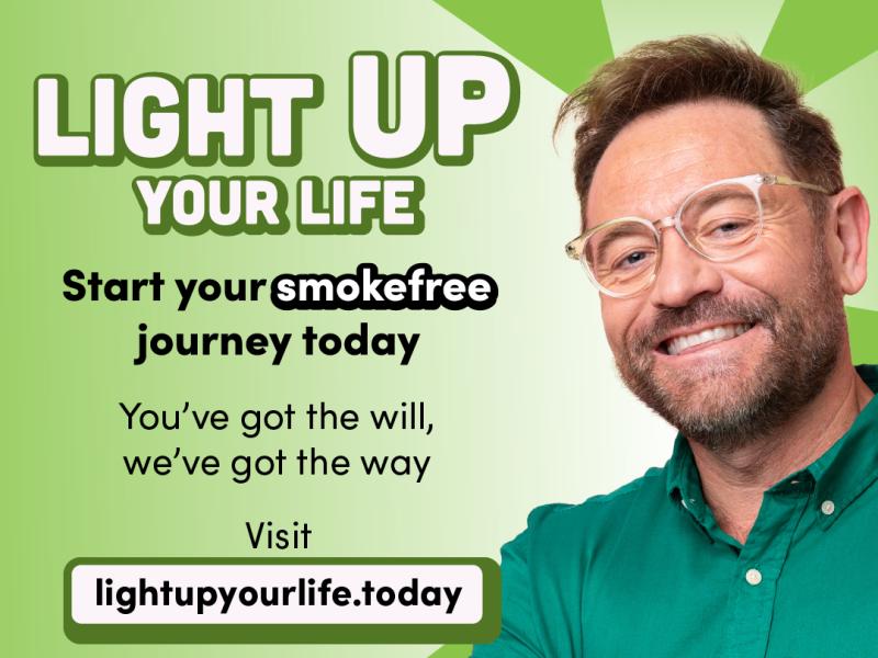 A promotional image for the Light Up Your Life campaign. A smiling man wearing a green shirt is stood next to the text "Light up your life", "Start your smokefree journey today". You've got the will, we've got the way. Visit lightupyourlife.today