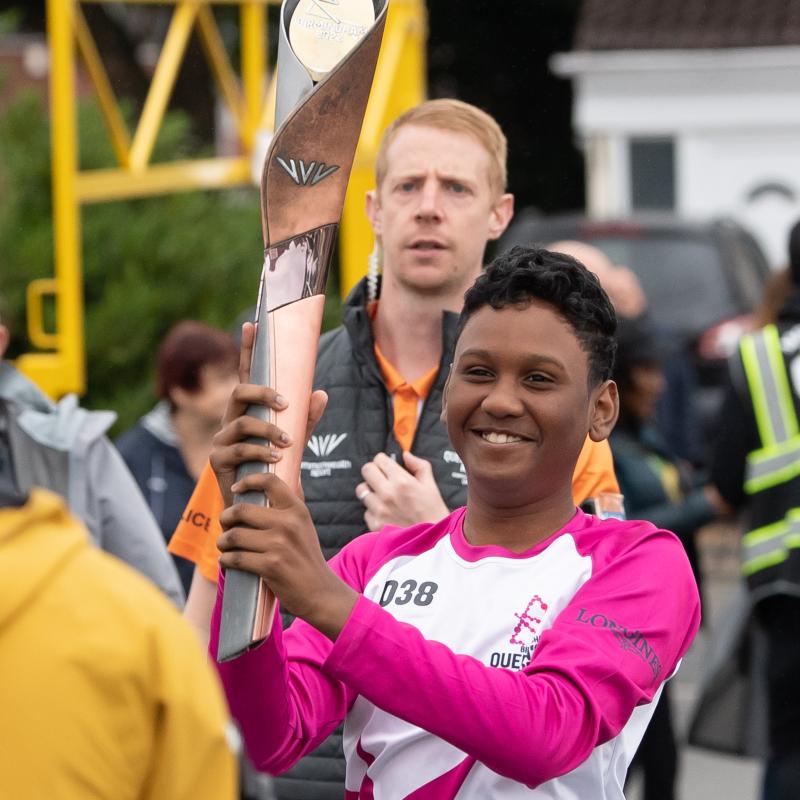 Child mascot with baton