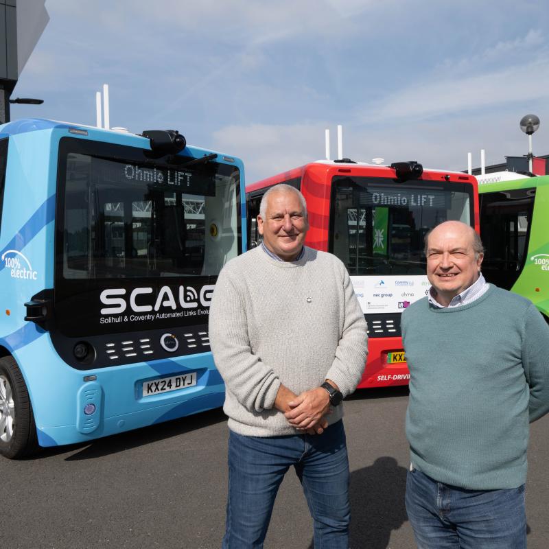 Cllr Andy Mackiewicz (right) with Ian Pulford from Ohmio (left) stood in front of the SCALE fleet