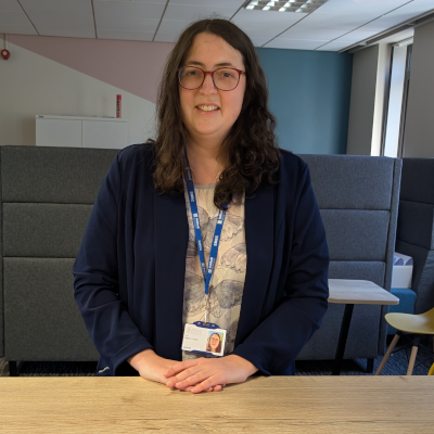 Person smiling while standing in the office